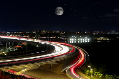 a long exposure photo of a highway at night
