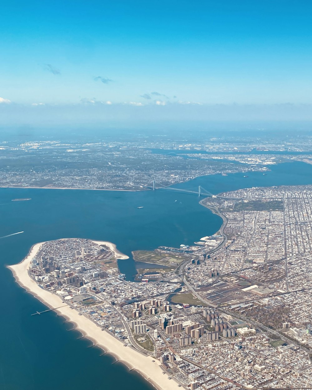 an aerial view of a city and a body of water