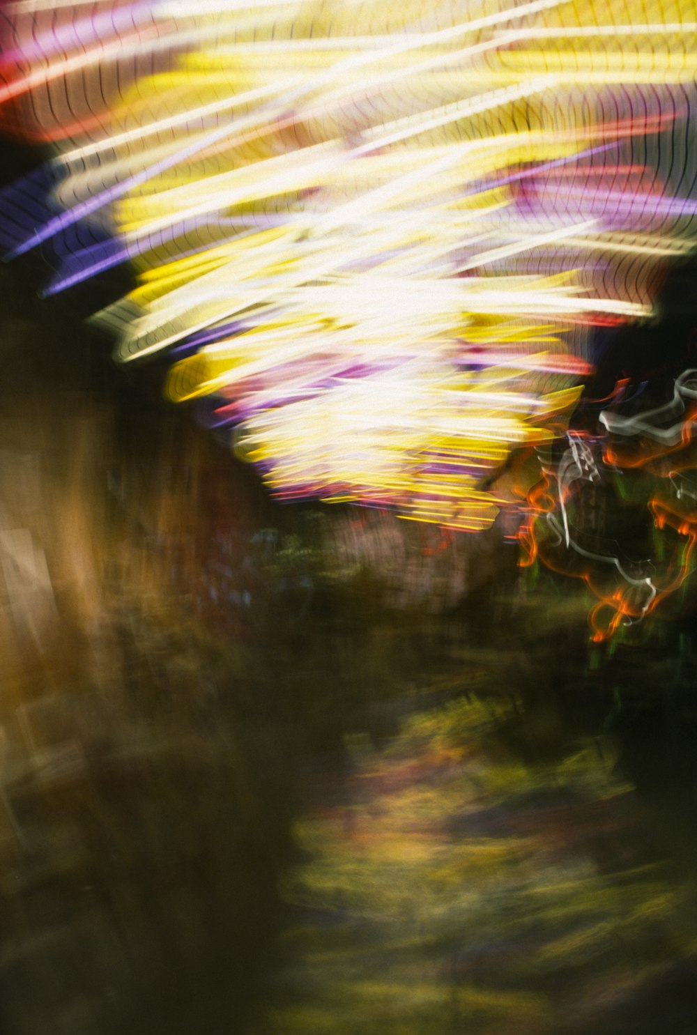 a blurry photo of a carnival ride at night