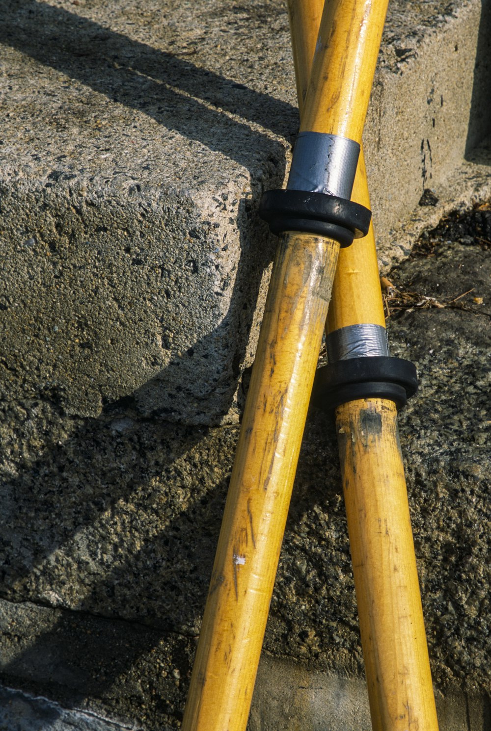 a pair of yellow poles sticking out of the ground