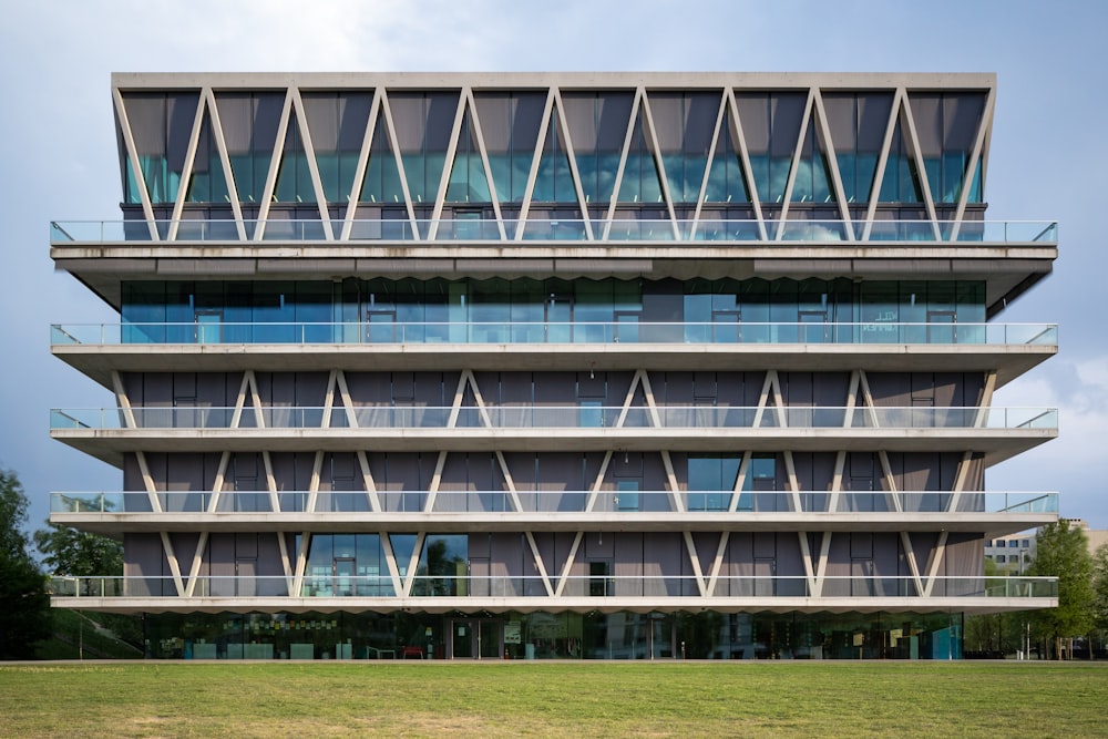 a large green field in front of a building