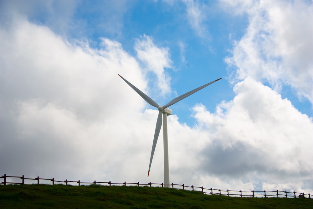 a wind turbine on top of a hill