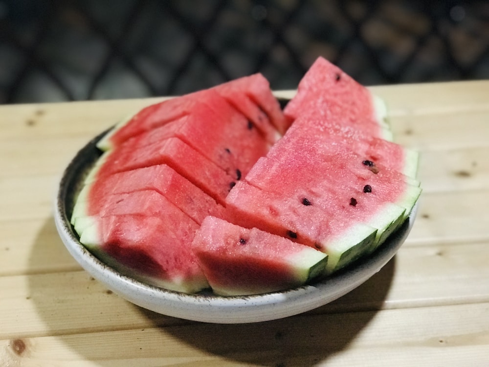 slices of watermelon in a bowl on a table