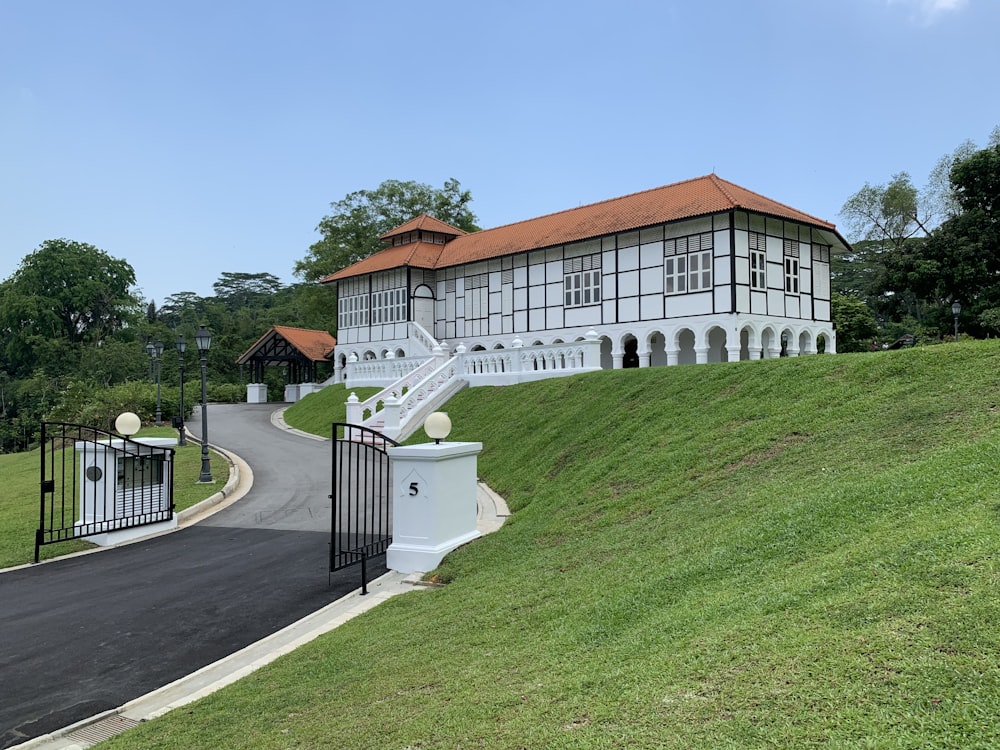 a large white building with a red roof on top of a hill