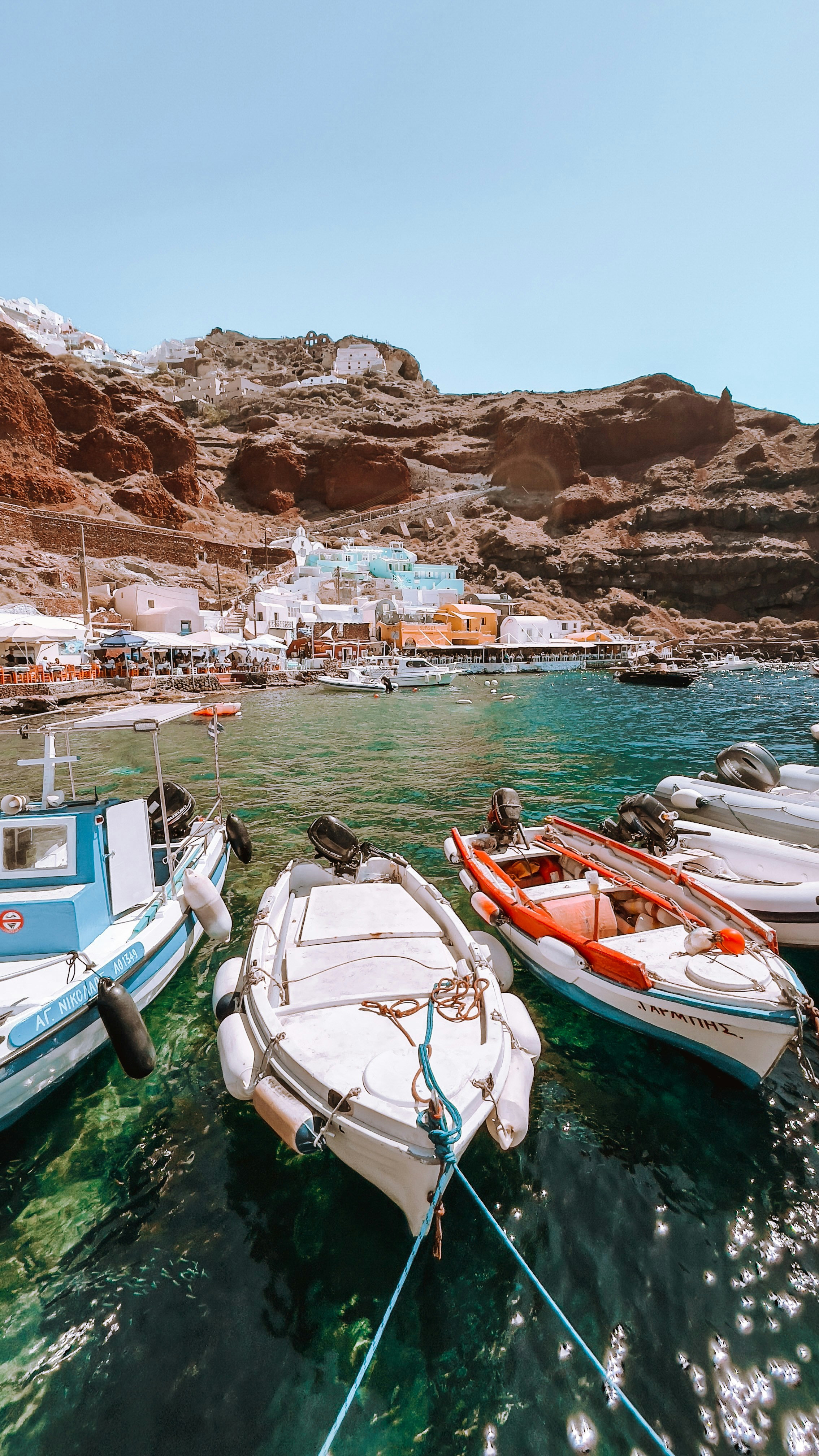 a group of small boats tied to a dock