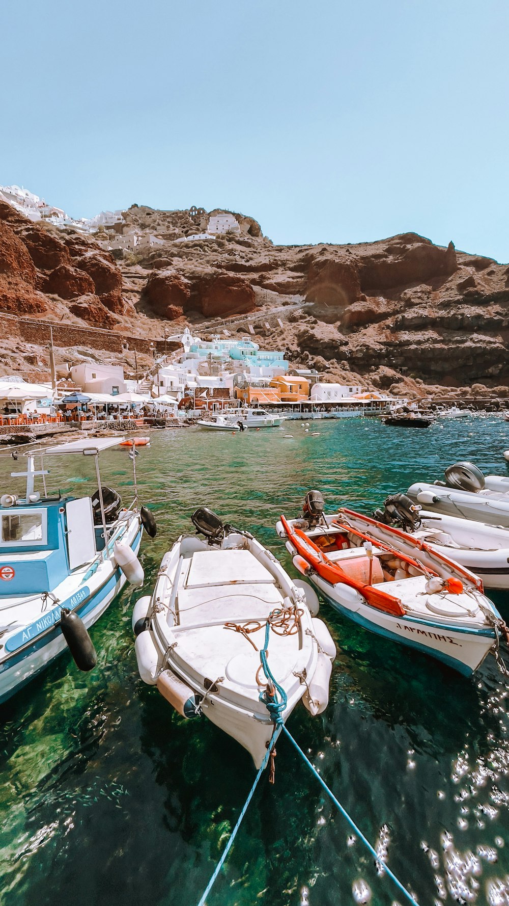 a group of small boats tied to a dock