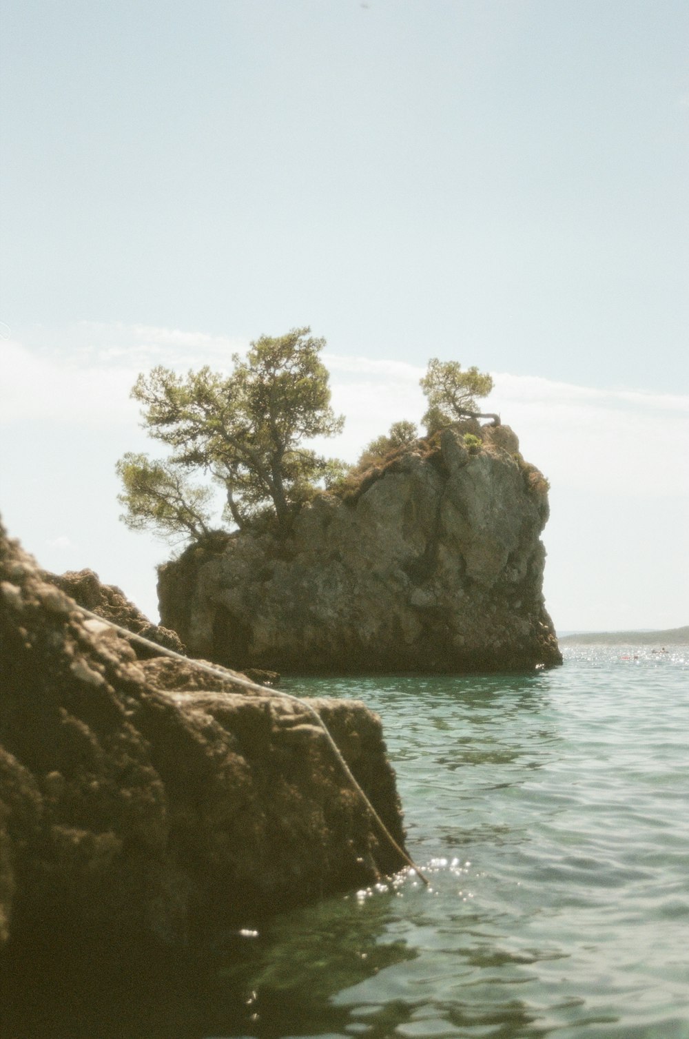 a rock outcropping in the middle of a body of water