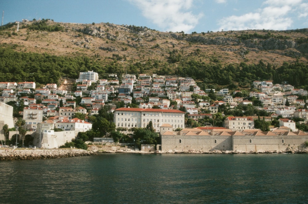 a view of a city on a hill next to a body of water
