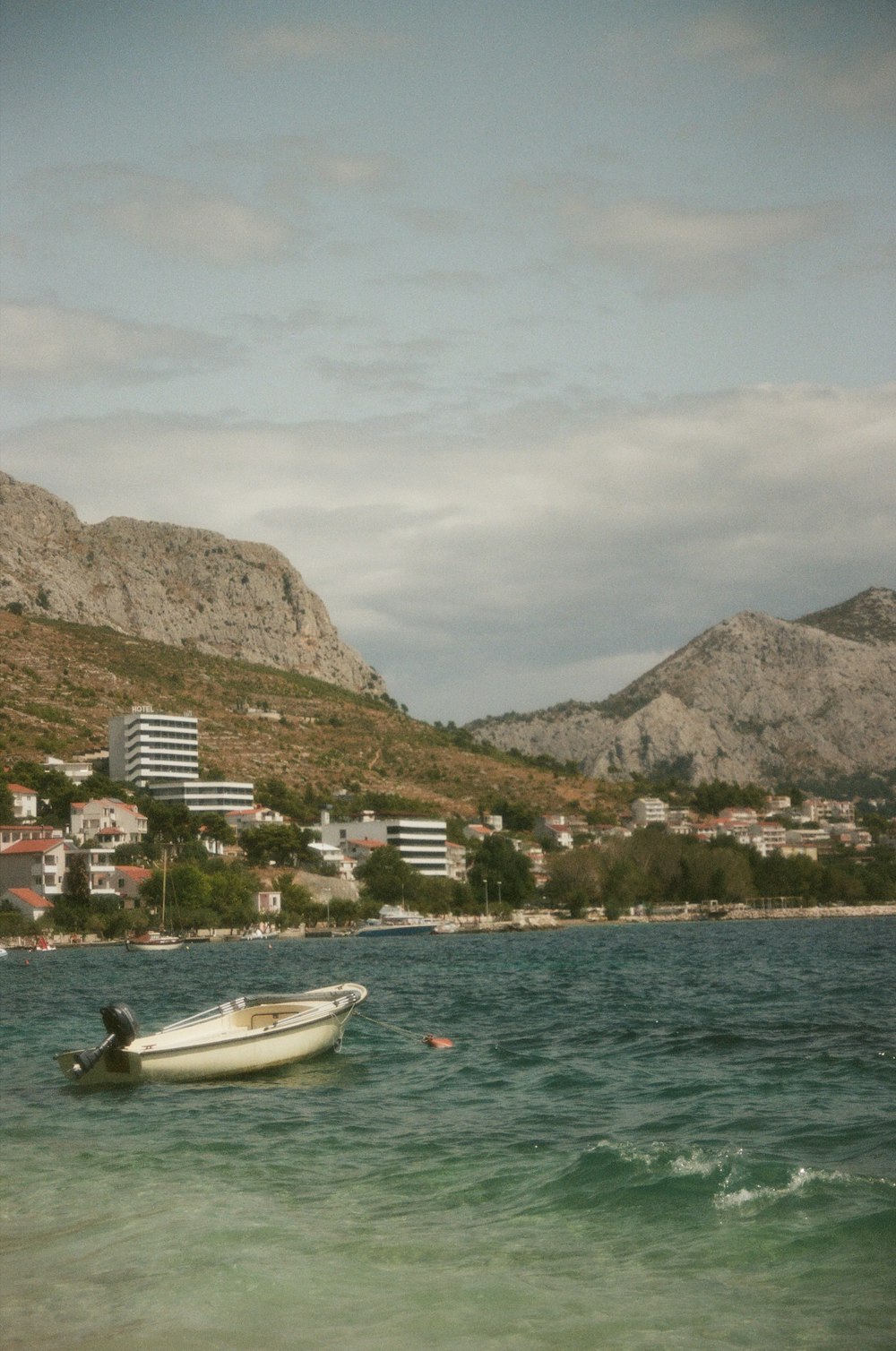 a small boat floating on top of a body of water