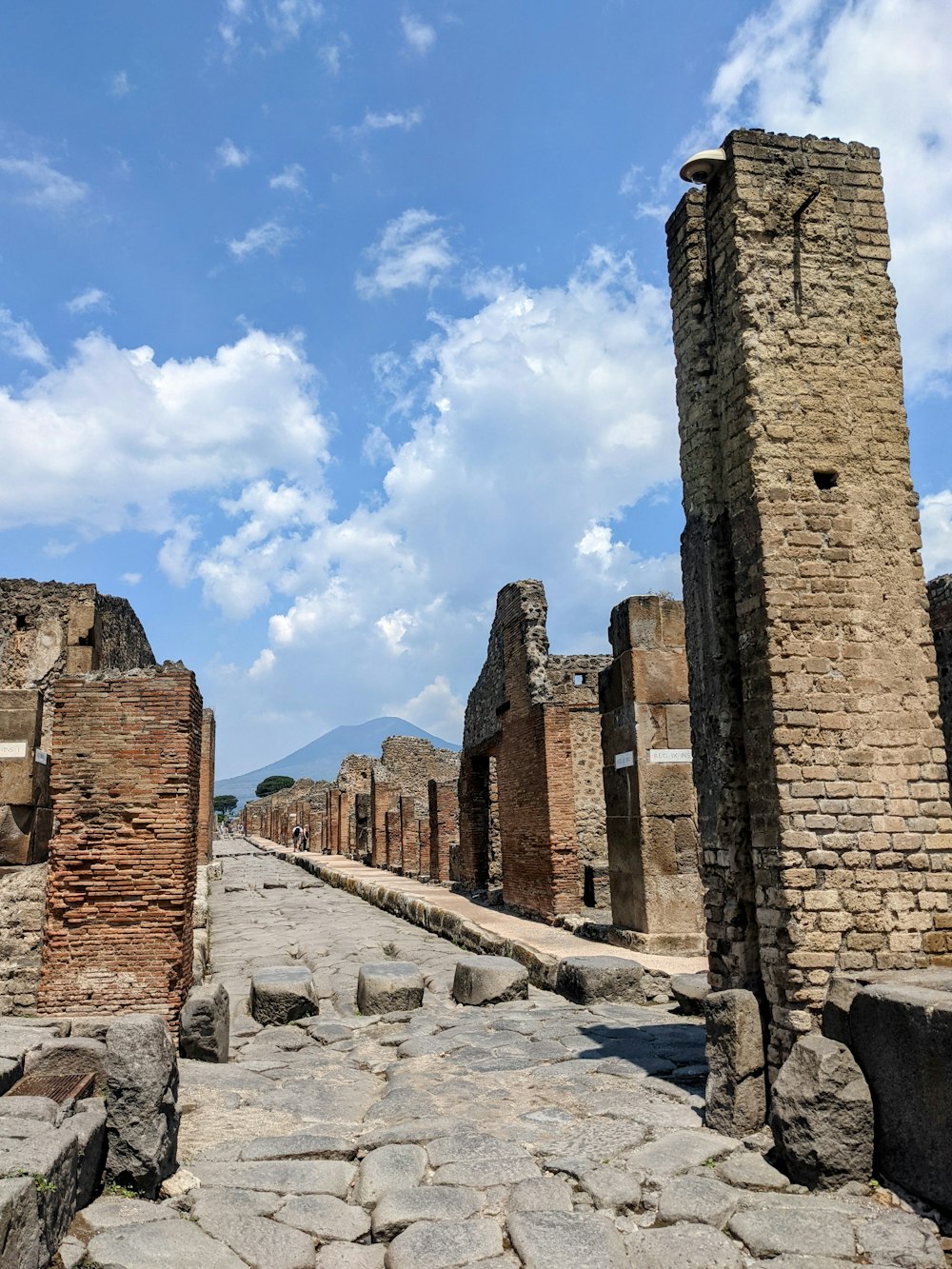 a cobblestone street lined with stone buildings