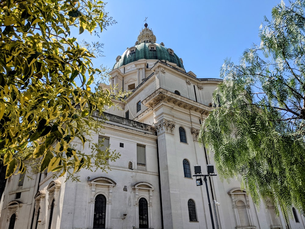 a large white building with a green dome