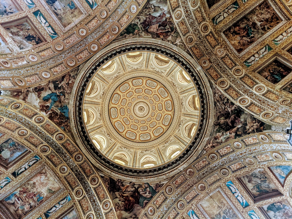 the ceiling of a building with paintings on it