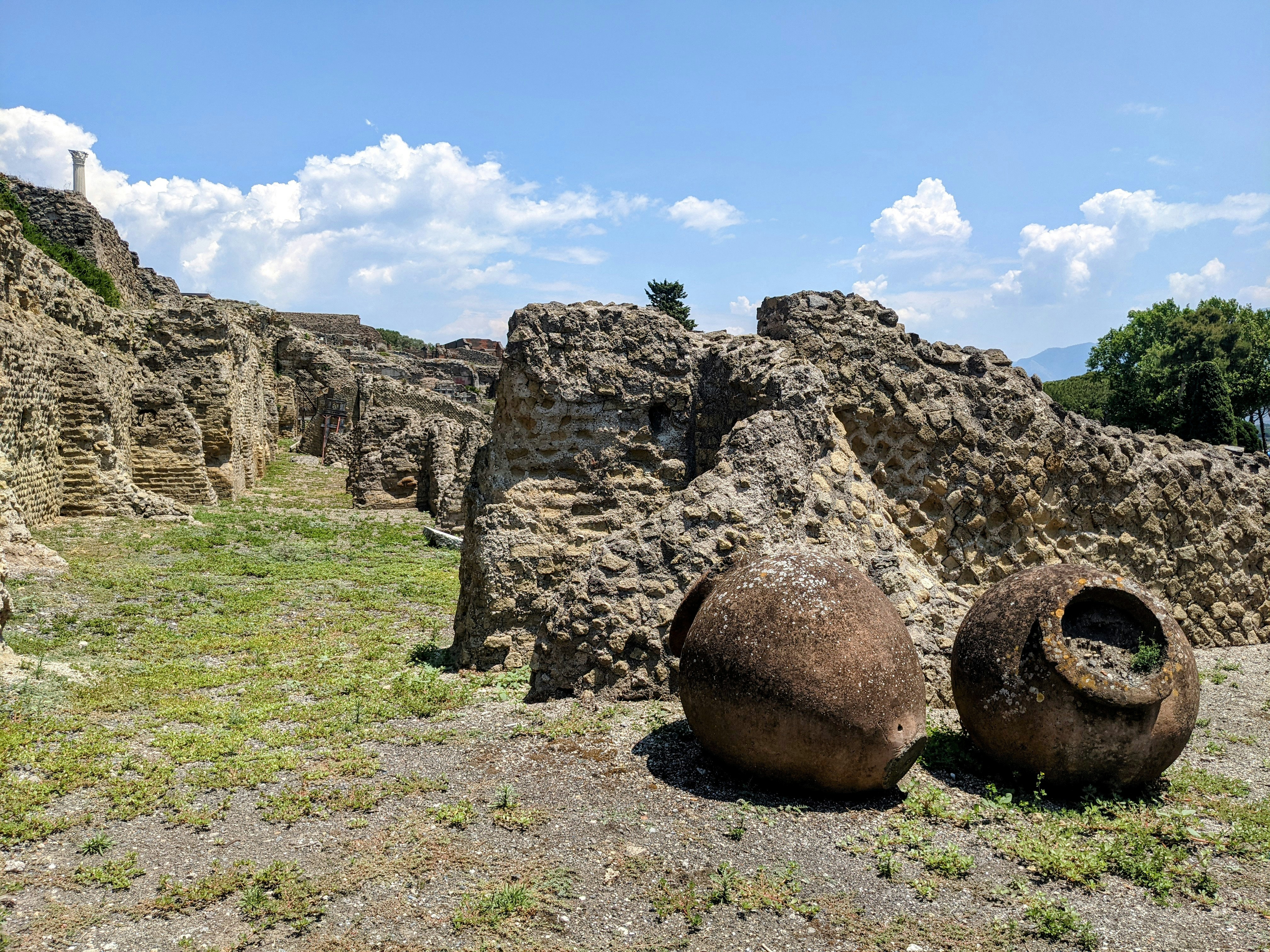 a couple of large rocks sitting on top of a grass covered field