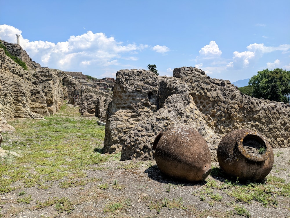 a couple of large rocks sitting on top of a grass covered field