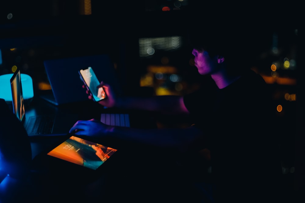 a man sitting at a desk using a laptop computer