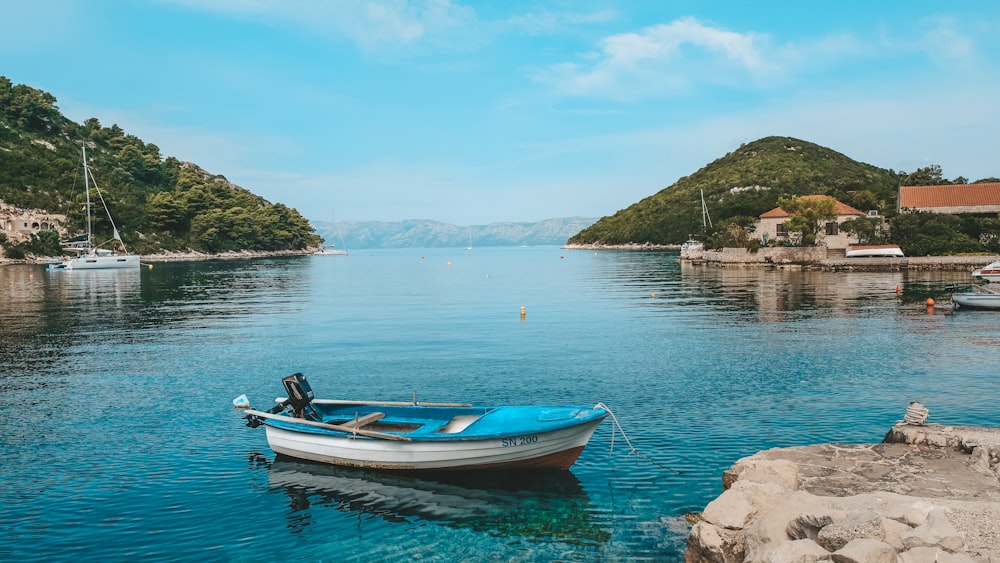 a small boat floating on top of a body of water