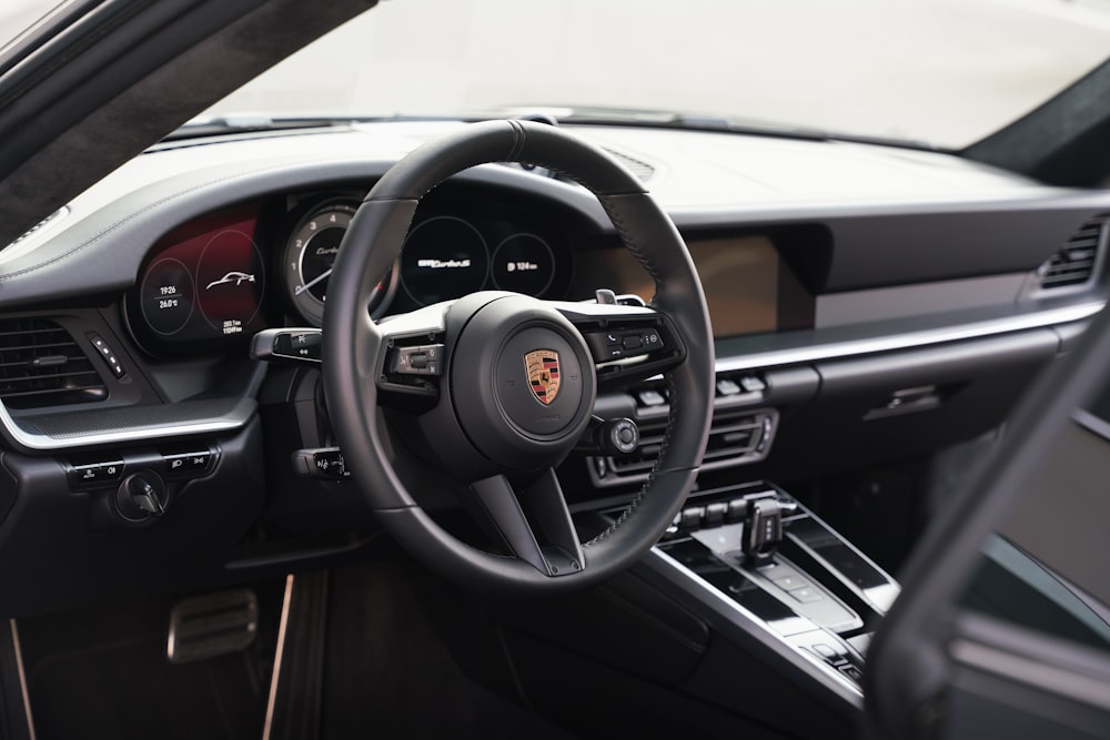 the interior of a car with a steering wheel and dashboard