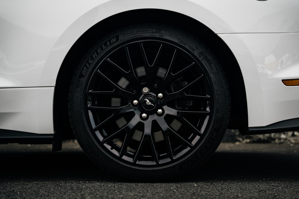 a close up of a car tire on a street