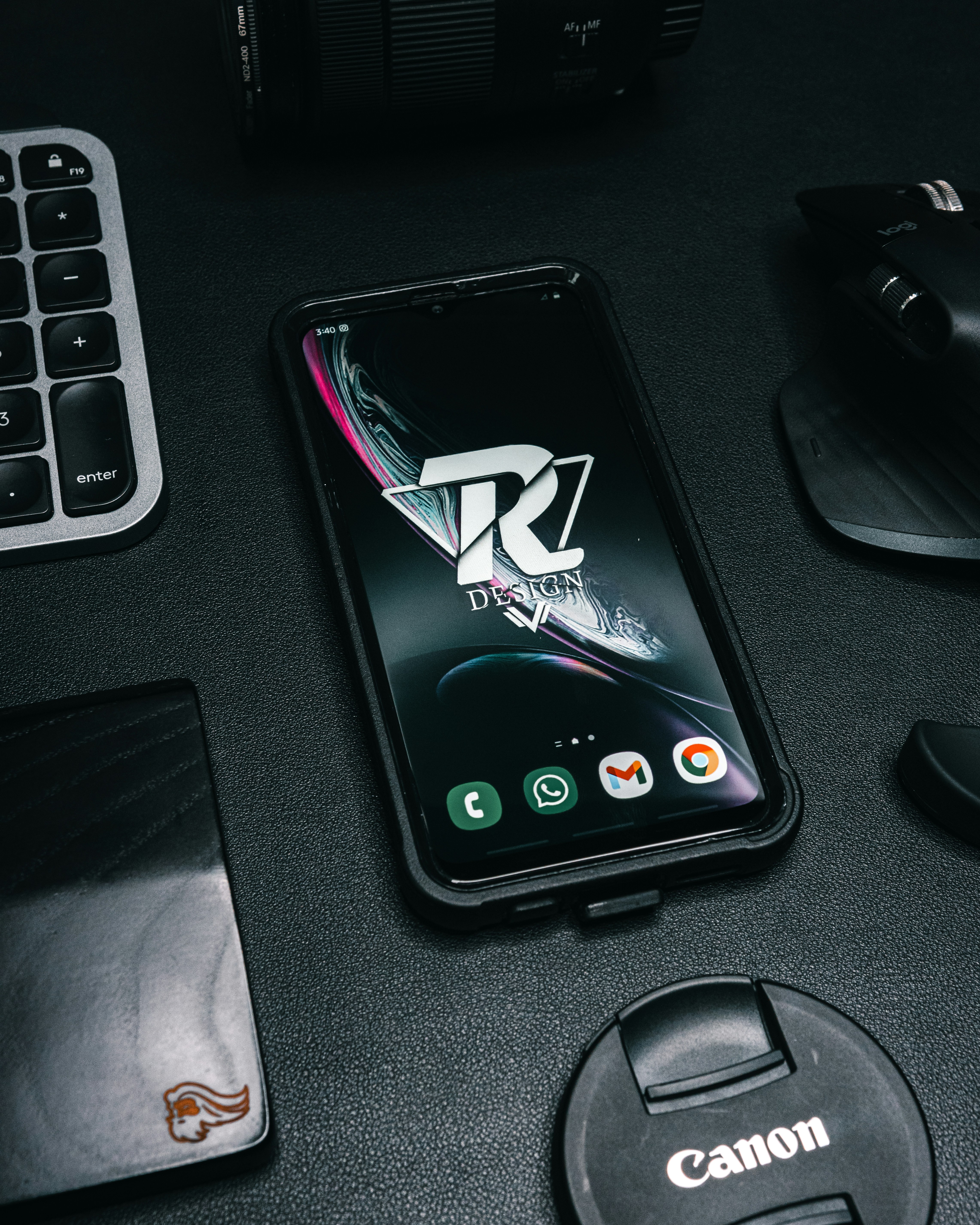 a cell phone sitting on top of a desk next to a keyboard