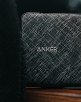 a speaker sitting on top of a wooden table