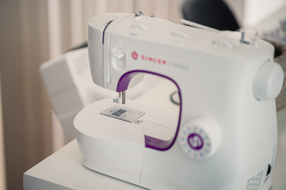 a white sewing machine sitting on top of a table