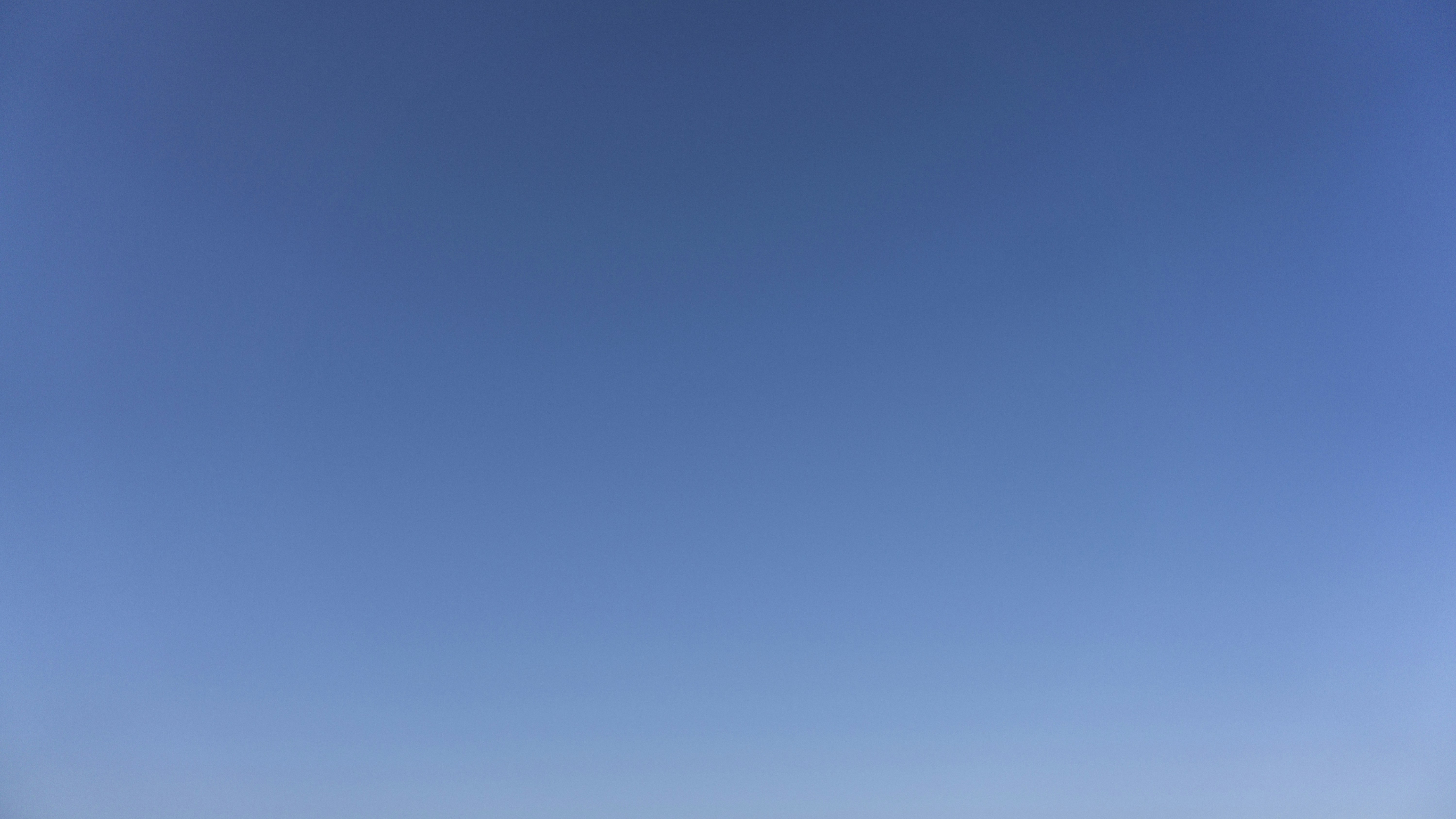 a group of people standing on top of a sandy beach
