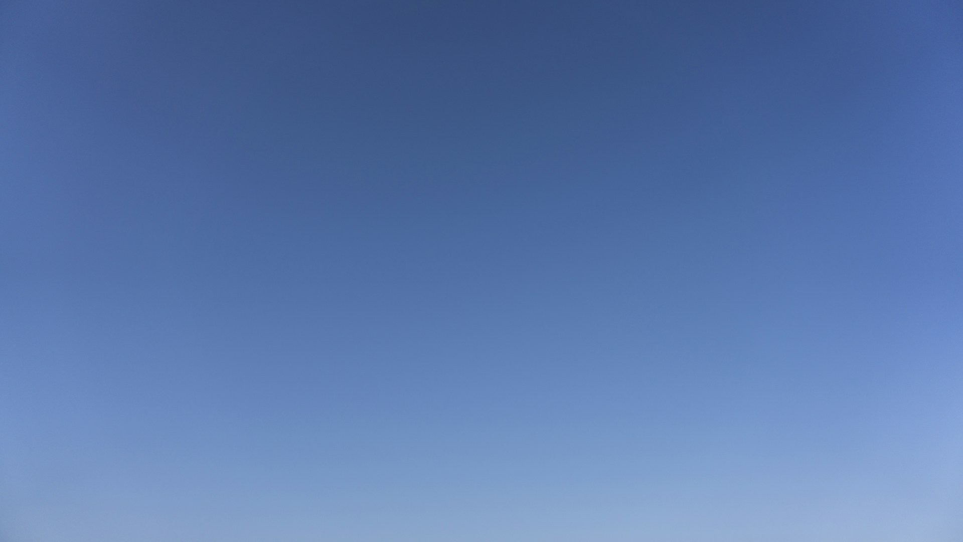 a group of people standing on top of a sandy beach