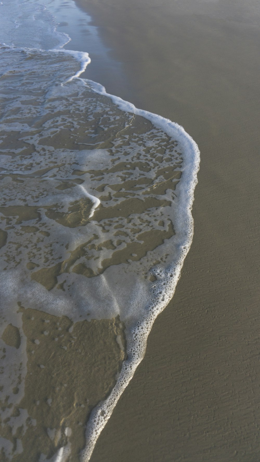 a beach with waves coming in to the shore