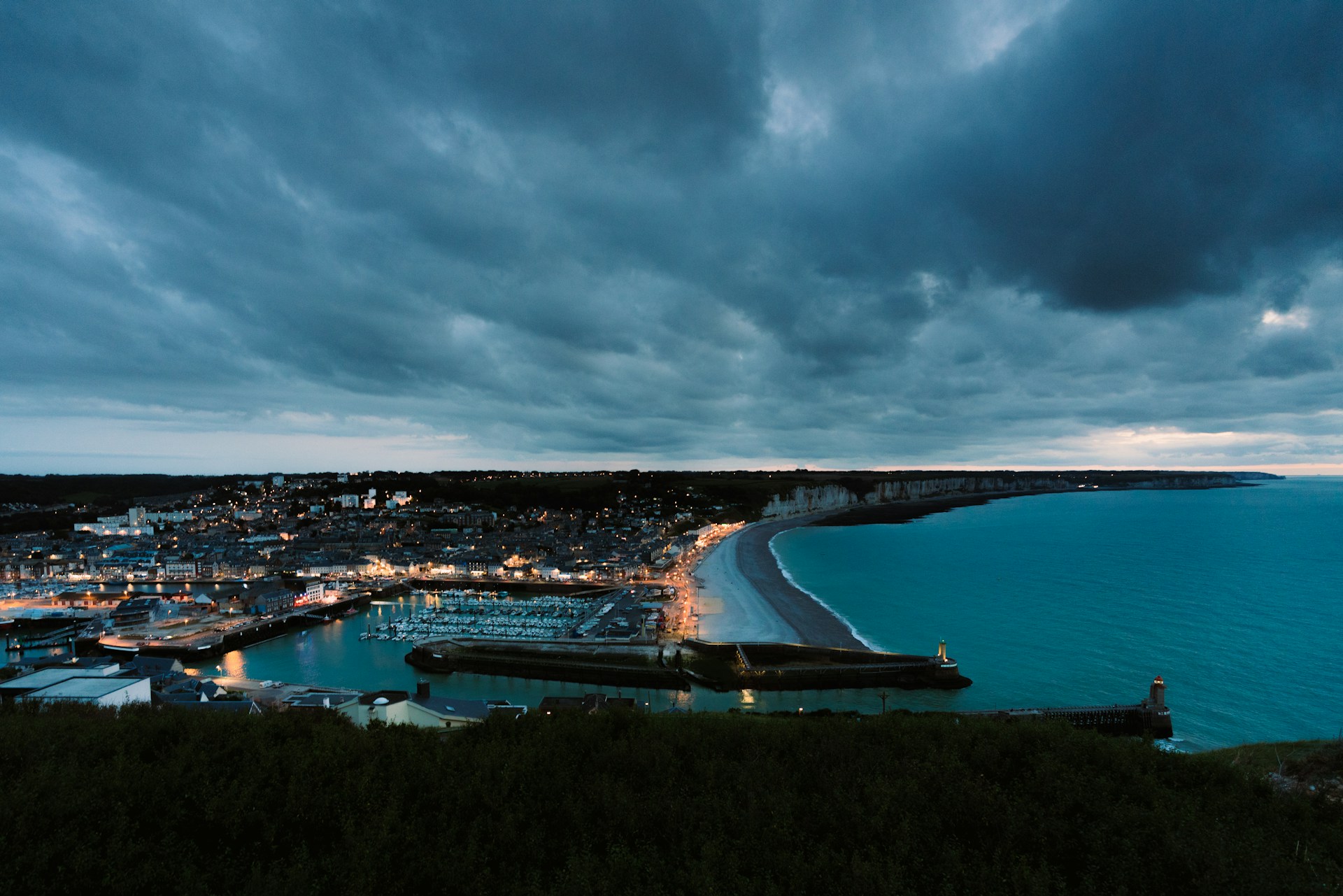 a view of a harbor and a city at night