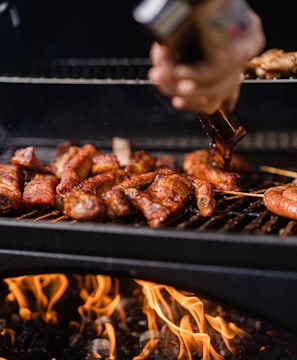 a person is cooking food on a grill