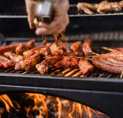 a person is cooking meat on a grill