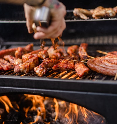 a person is cooking meat on a grill