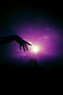 a person reaching out to another person's hand