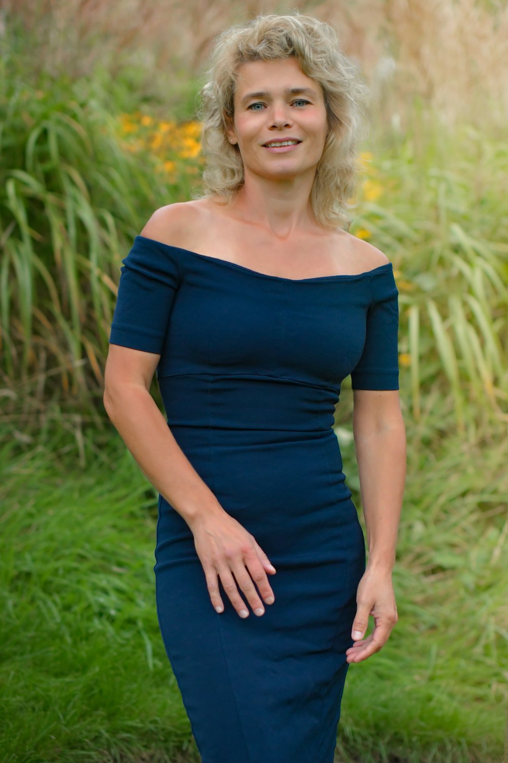 a woman in a blue dress posing for a picture