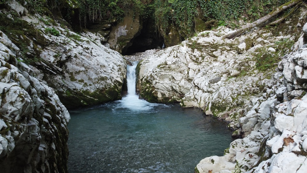 a small waterfall in the middle of some rocks