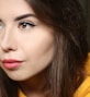 a close up of a person wearing a yellow shirt