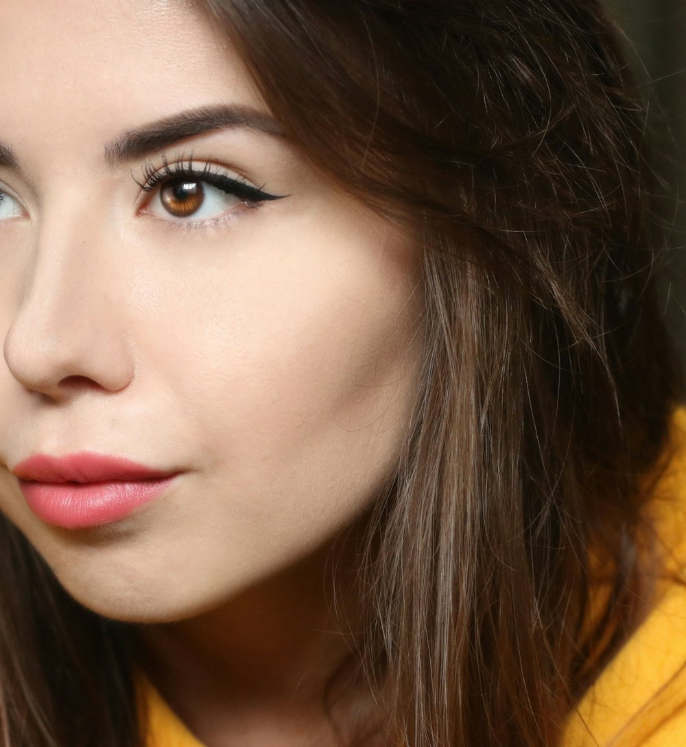 a close up of a person wearing a yellow shirt