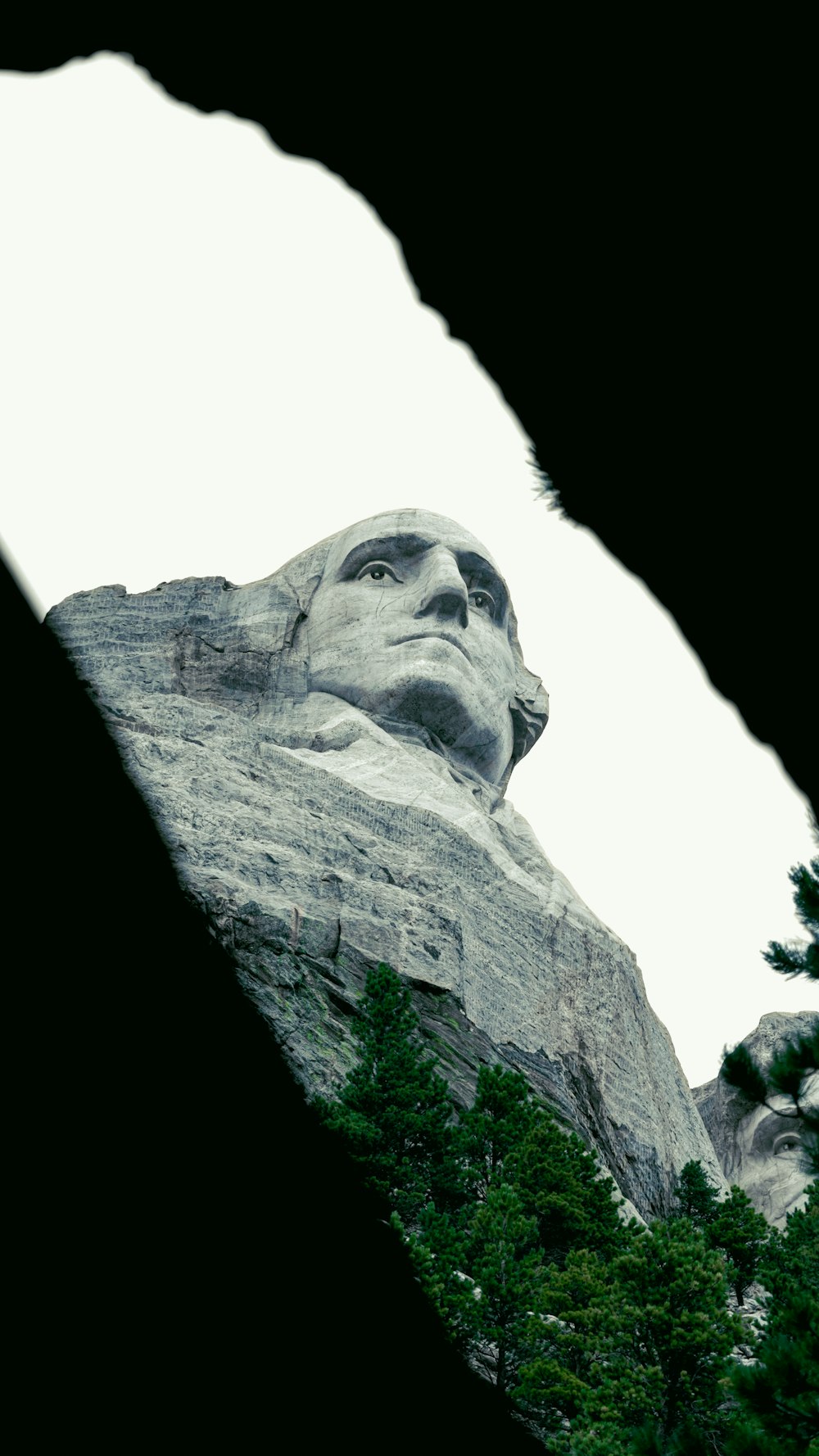 a view of the statue of abraham lincoln through a hole in the side of a