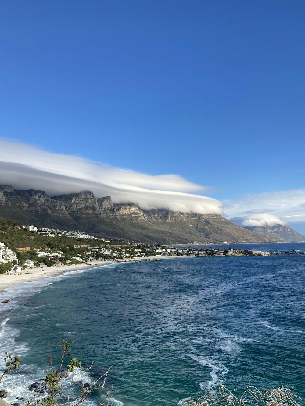 a large body of water with a mountain in the background