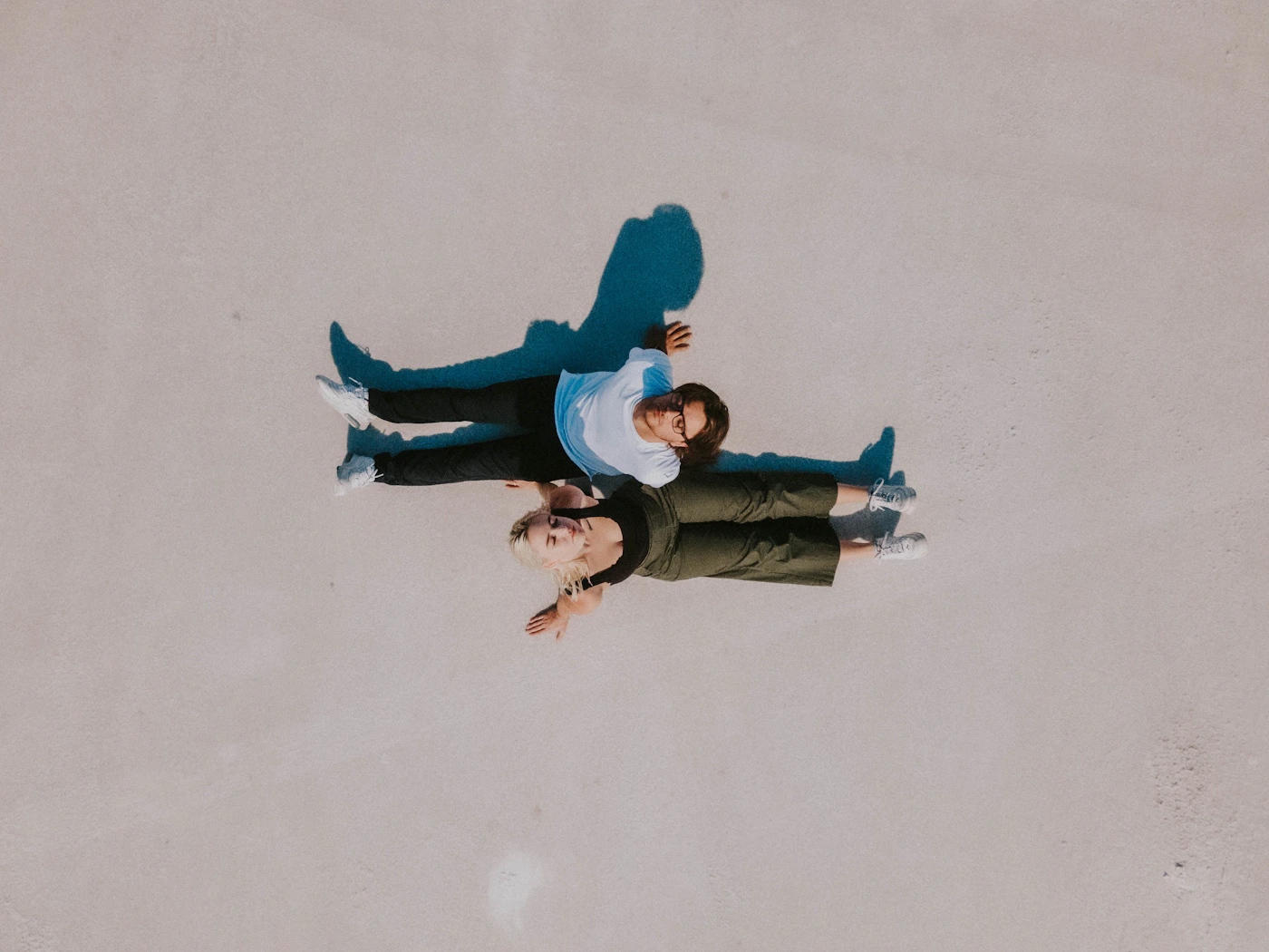 Couple in formal elopement attire standing together in the Uyuni salt flat mirror reflection during the wet season