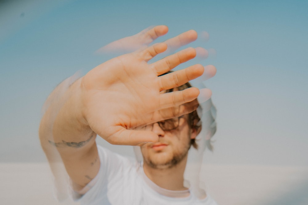 a man holding his hands up in the air