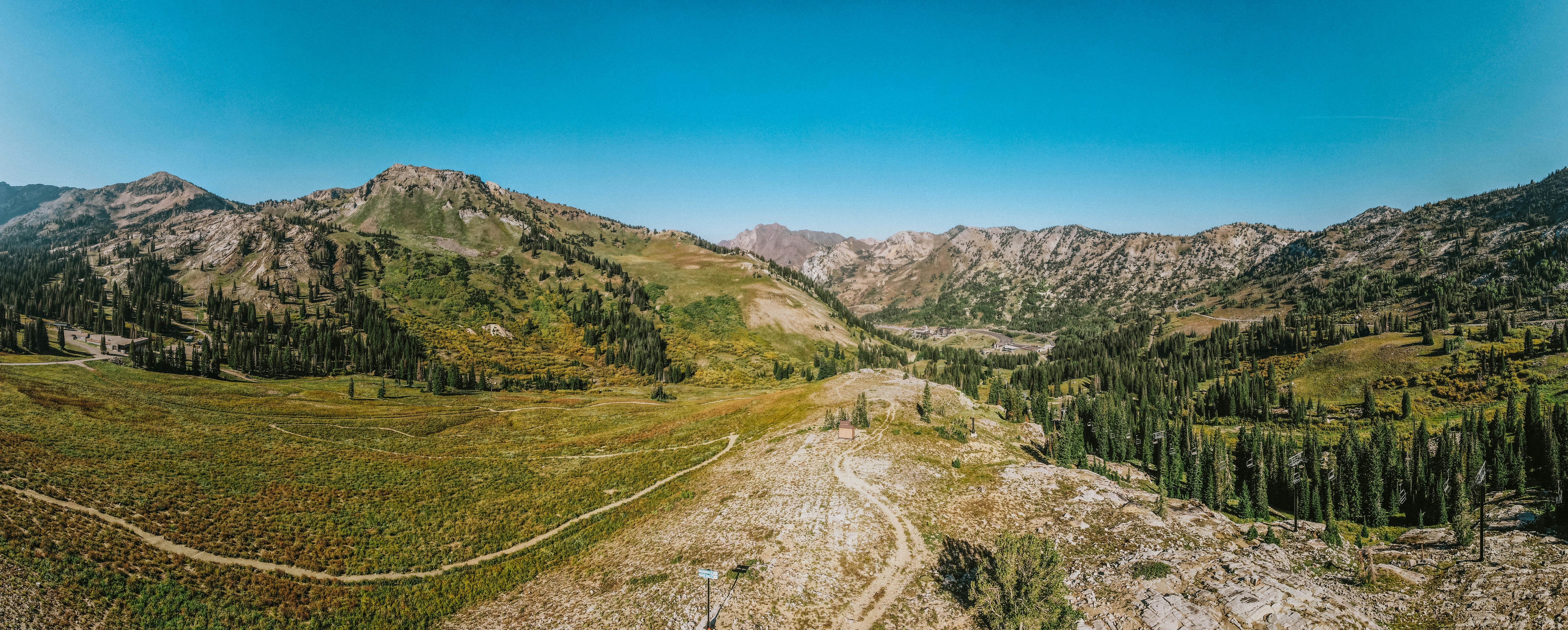an aerial view of a dirt road in the mountains, 