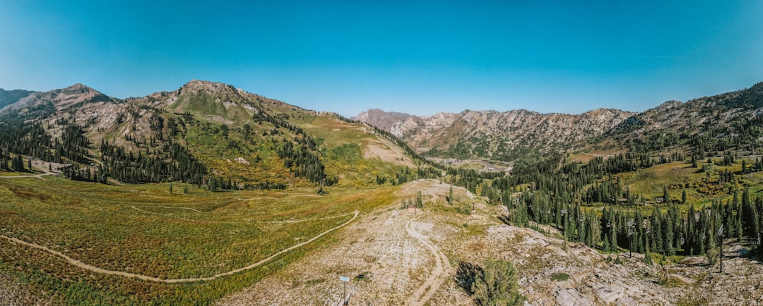 an aerial view of a dirt road in the mountains,
