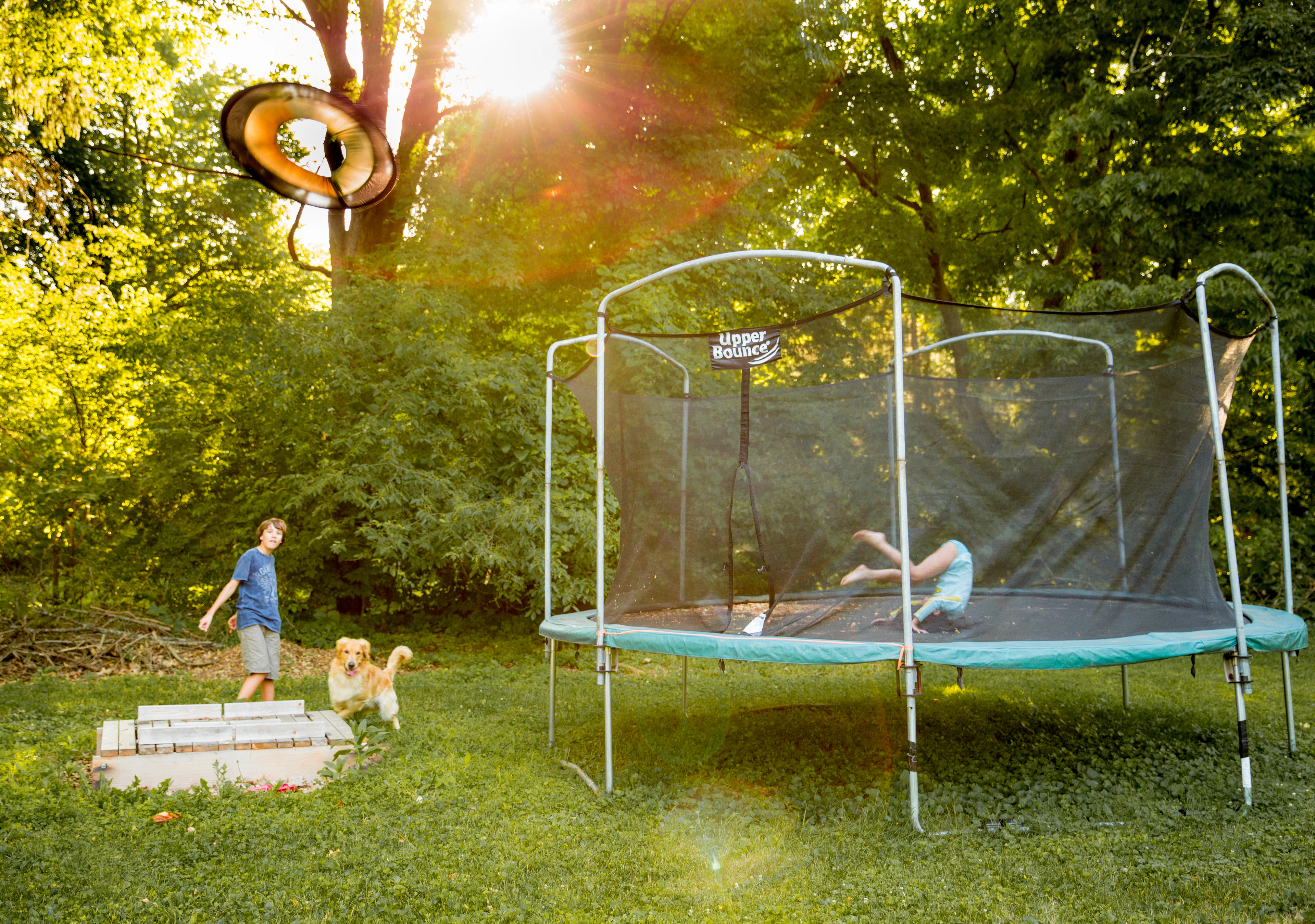 Children playing on a garden trampoline