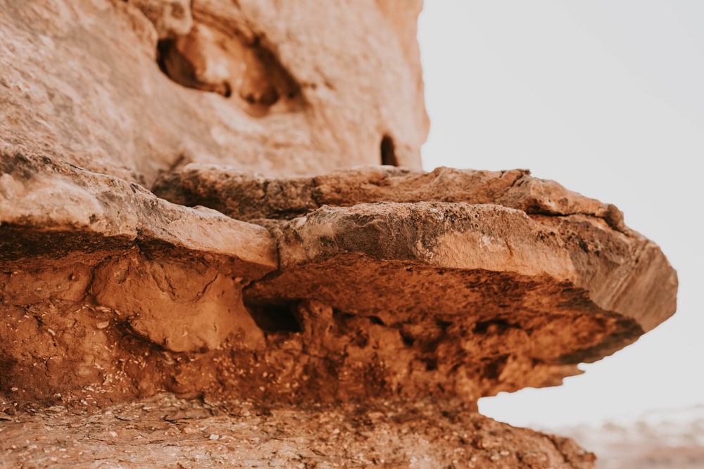 a close up of a rock formation with a sky in the background