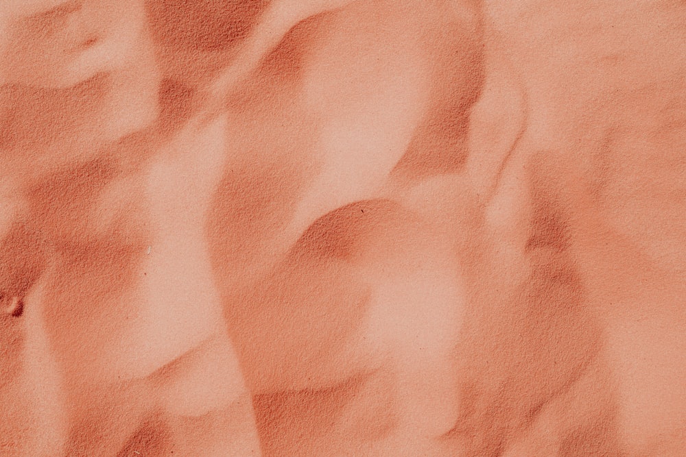 a close up of a sand dune with a sky background