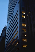 Evening view of a modern building with illuminated windows.