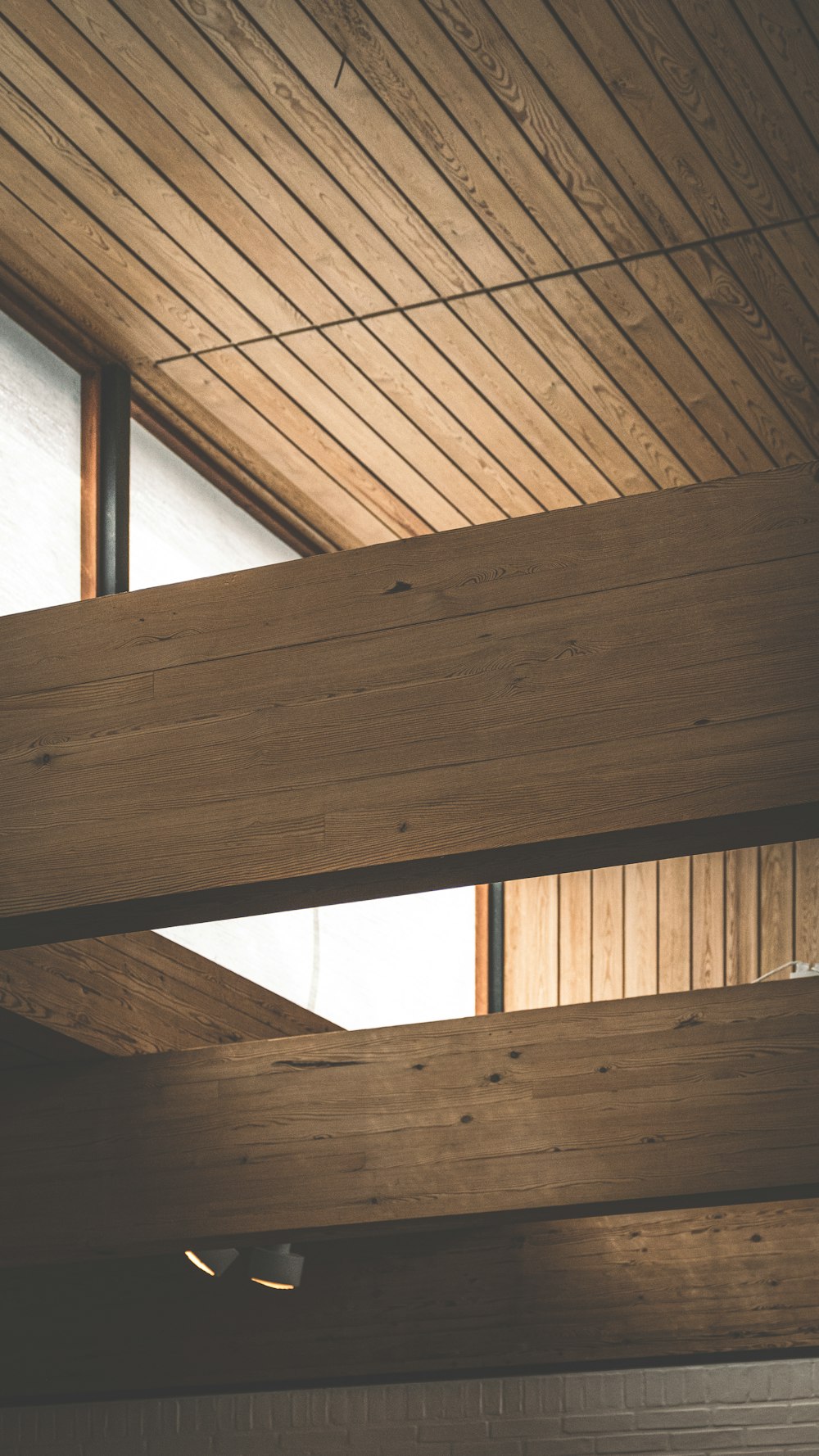 a close up of a wooden ceiling with a skylight