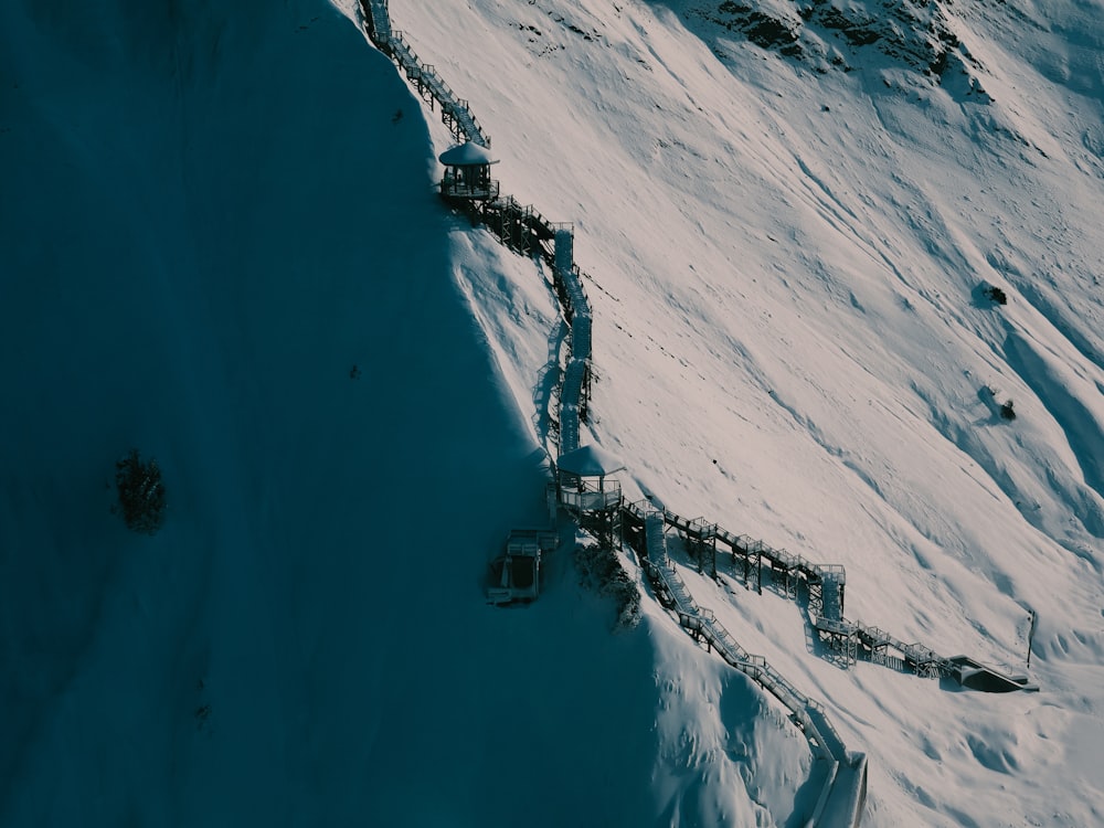 a snow covered mountain with a ladder going up the side of it