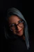 a woman with grey hair and glasses posing for a picture